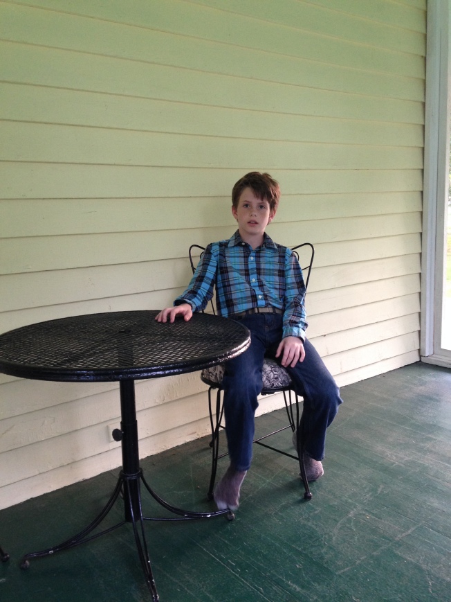 Jack on the screened porch.  I got the little table and chairs for a song at a store closing it's business. 